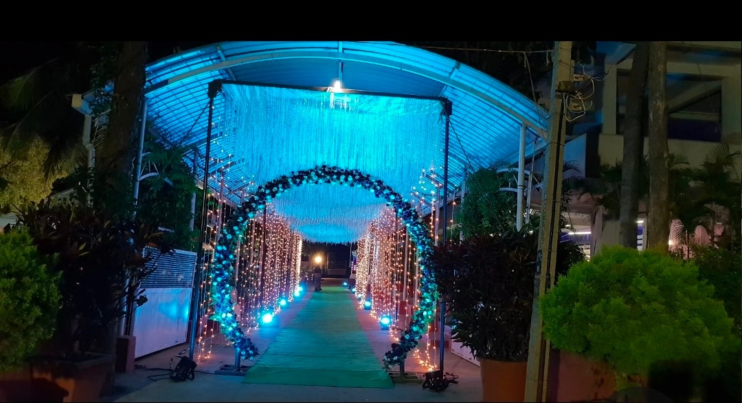 Illuminated blue floral arch tunnel entrance at Kalathur Gardens